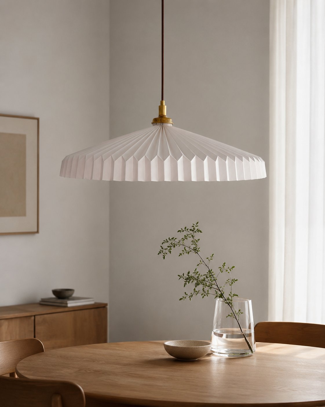 Wide saucer pendant lamp over a round table